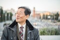 Japanese senior old man outdoors smiling and happy portrait