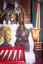 Shrine to smiling Buddha with many gifts