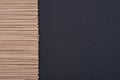 Japanese soba in a row on a dark grey background forming the frame for text. Uncooked noodle top view with copy space