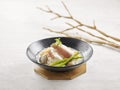 Japanese Somen with Grouper Fillet in Fish Soup served in a dish side view on grey background