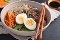 Japanese soup with Enoki mushrooms, soba noodles, and vegetables Royalty Free Stock Photo