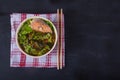 Japanese soup with vegetables and fish on a linen napkin on a black background. Copy spaes