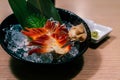 Japanese Stimpson surf clam or Clam Pinion or hokkigai sashimi with ice and glass black bowl on the table. Fresh raw seafood of Royalty Free Stock Photo