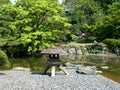 Japanese stone lantern and koi pond at the imperial palace in tokyo Royalty Free Stock Photo