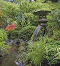 Japanese Stone Lantern by Water Stream Royalty Free Stock Photo