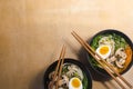 Japanese street food. Traditional japanese Ramen soup with mushrooms, Bok Choy, greens on the orange background