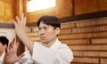 Japanese student, aikido or training martial arts in dojo for practice, fighting education or self defense. Combat