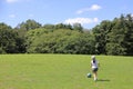 Japanese student girl playing soccer on the grass Royalty Free Stock Photo