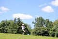 Japanese student girl playing soccer on the grass