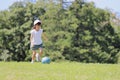 Japanese student girl playing soccer on the grass Royalty Free Stock Photo