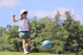 Japanese student girl playing soccer on the grass Royalty Free Stock Photo