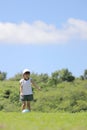 Japanese student girl playing soccer on the grass Royalty Free Stock Photo