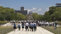 Japanese students visiting the Hiroshima Victims Memorial Cenotaph in the background Genbaku Dome World Heritage Monument