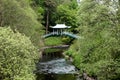 Japanese Style Bridge over a River in a Country Park Royalty Free Stock Photo