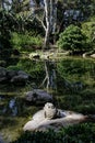 Japanese Style Garden With Pond and Stone Sculpture
