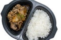 Japanese style lunch box with beef, rice and vegetables in black plastic container on white background Royalty Free Stock Photo