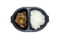 Japanese style lunch box with beef, rice and vegetables in black plastic container on white background. Royalty Free Stock Photo