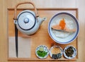 Japanese style lunch set with appetizer, Deep fried salmon on rice served with soup in pot. Top view