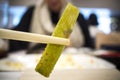 Japanese-Style Sesame Green Bean between chopsticks