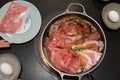 Japanese sukiyaki hot pot with vegetable, beef slice, raw egg cooking in hot pot