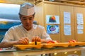 Japanese sushi chef prepares dishes of traditional sushi Royalty Free Stock Photo