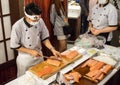 Japanese Sushi chef shows ` how to slice a salmon fillet ` at Seafood festival , Seacon Square shopping center.