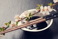 Japanese sushi chopsticks, soy sauce bowl and sakura blossom Royalty Free Stock Photo