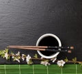 Japanese sushi chopsticks, soy sauce bowl and sakura blossom