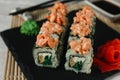 Japanese sushi, food art. Uramaki on black slate. Royalty Free Stock Photo