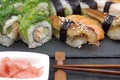 Japanese sushi food on a black tray, served with ginger, soy sauce and seaweed salad Royalty Free Stock Photo