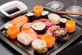 Japanese sushi food. Maki ands rolls with tuna, salmon, shrimp, crab and avocado on black dish
