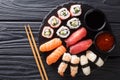 Japanese sushi food. Maki ands rolls with tuna, salmon, shrimp, crab and avocado with two sauces close-up on a slate. horizontal Royalty Free Stock Photo