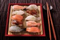 Japanese sushi food various assortment red bamboo tray chopsticks Royalty Free Stock Photo