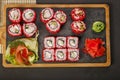 Japanese sushi roll set with red flying fish caviar. Pickled ginger, spicy wasabi paste and soy sauce. Top view Royalty Free Stock Photo