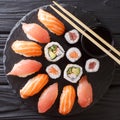 Japanese sushi on a rustic dark background. Sushi rolls, nigiri, maki, soy sauce. Sushi set on a table. Asian food. top view from Royalty Free Stock Photo