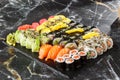 Japanese sushi set. Set of fresh tuna maki , salmon nigiri and dragon sushi rolls served on black plate close-up. Horizontal top Royalty Free Stock Photo