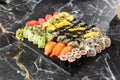 Japanese sushi set. Set of fresh tuna maki , salmon nigiri and dragon sushi rolls served on black plate close-up. Horizontal top Royalty Free Stock Photo