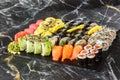 Japanese sushi set. Set of fresh tuna maki , salmon nigiri and dragon sushi rolls served on black plate close-up. Horizontal top Royalty Free Stock Photo