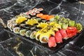 Japanese sushi set. Set of fresh tuna maki , salmon nigiri and dragon sushi rolls served on black plate close-up. Horizontal top Royalty Free Stock Photo