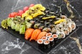 Japanese sushi set. Set of fresh tuna maki , salmon nigiri and dragon sushi rolls served on black plate close-up. Horizontal top Royalty Free Stock Photo