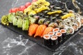 Japanese sushi set. Set of fresh tuna maki , salmon nigiri and dragon sushi rolls served on black plate close-up. Horizontal top Royalty Free Stock Photo