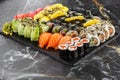 Japanese sushi set. Set of fresh tuna maki , salmon nigiri and dragon sushi rolls served on black plate close-up. Horizontal top Royalty Free Stock Photo