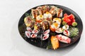 Japanese sushi set. Set of fresh tuna maki , salmon nigiri and dragon sushi rolls served on black plate close-up. Horizontal top Royalty Free Stock Photo