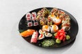 Japanese sushi set. Set of fresh tuna maki , salmon nigiri and dragon sushi rolls served on black plate close-up. Horizontal top Royalty Free Stock Photo