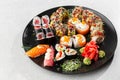 Japanese sushi set. Set of fresh tuna maki , salmon nigiri and dragon sushi rolls served on black plate close-up. Horizontal top Royalty Free Stock Photo