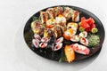 Japanese sushi set. Set of fresh tuna maki , salmon nigiri and dragon sushi rolls served on black plate close-up. Horizontal top Royalty Free Stock Photo