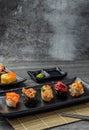 Japanese sushi set in ceramic empty plate dark Placed on the table concrete grunge texture background Royalty Free Stock Photo