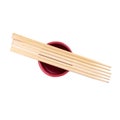 Japanese sushi sticks or chopsticks over red sauce bowl isolated on white background. Top view Royalty Free Stock Photo