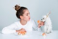 Japanese sushi style. Fashion portrait of beauty model girl eating sushi rolls, japanese food. Beautiful woman holding