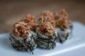 Japanese sushi with tuna and algae. Close up of sushi rolls on white plate. Royalty Free Stock Photo